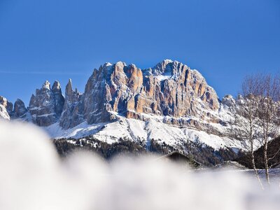 View of Italian mountains covered in snow on sunny clear blue sky day, Italy 