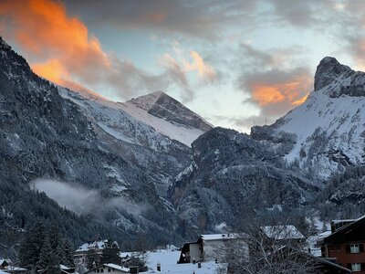 Fiery clouds during sunset over village, Winter Walks in Kandersteg, Swiss Alps