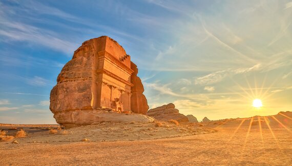 Spectacular sculpted rock temple in he desert of Saudi Arabia bathed in sun light