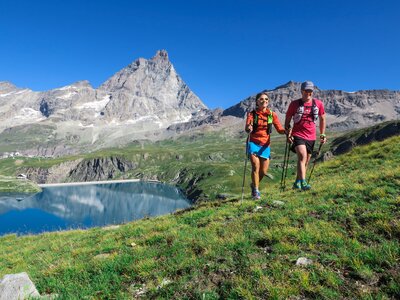 Walkers traversing the mountains in Aosta in Italy's northwestern Alps
