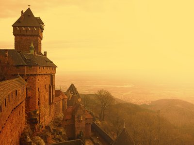 Haut-Koenigsbourg castle during golden sunset in fog, Alsace, France