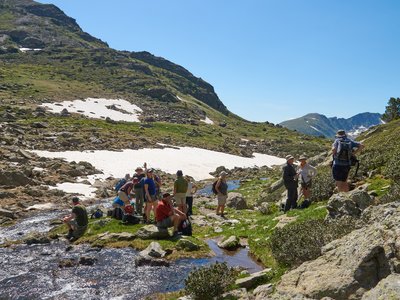 Walking group resting by Tristania Lakes, Andorra, Europe