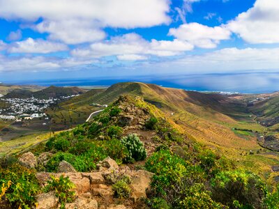 Expansive landscape view of volcanic island with Haria village in distance, Lanzarote, Canary Islands, Spain