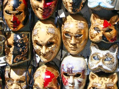 Colourful and decorated venetian masks displayed in street, Venice, Italy