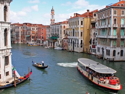 Vaporetto water bus and gondolas on the Grand Canal in Venice, Italy