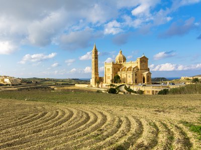 Distant view of Ta Pinu Basilica from plowfields, Gozo Island, Malta