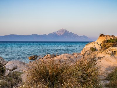 Sea view to mountain outline of Athos from rocky terrain, Sithonia, Greece